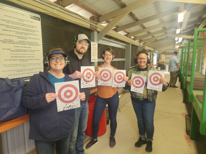 Gun Girl Training students holding their targets on the range at Kent County Conservation League in Ada, Michigan